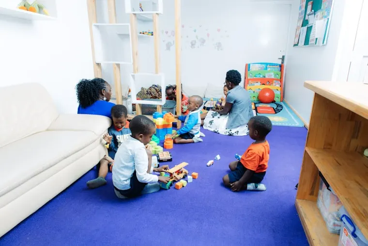 Children settling into play in a bright classroom