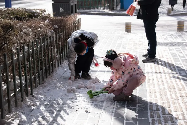 Children playing outside in the snow